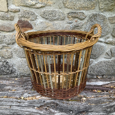 Willow can basket against a stone wall