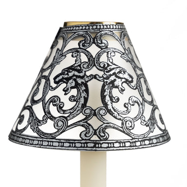 Translucent candle shade with silver filigree pattern on cream candle with white background