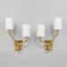 Cylindrical cream lampshades on brass wall lights