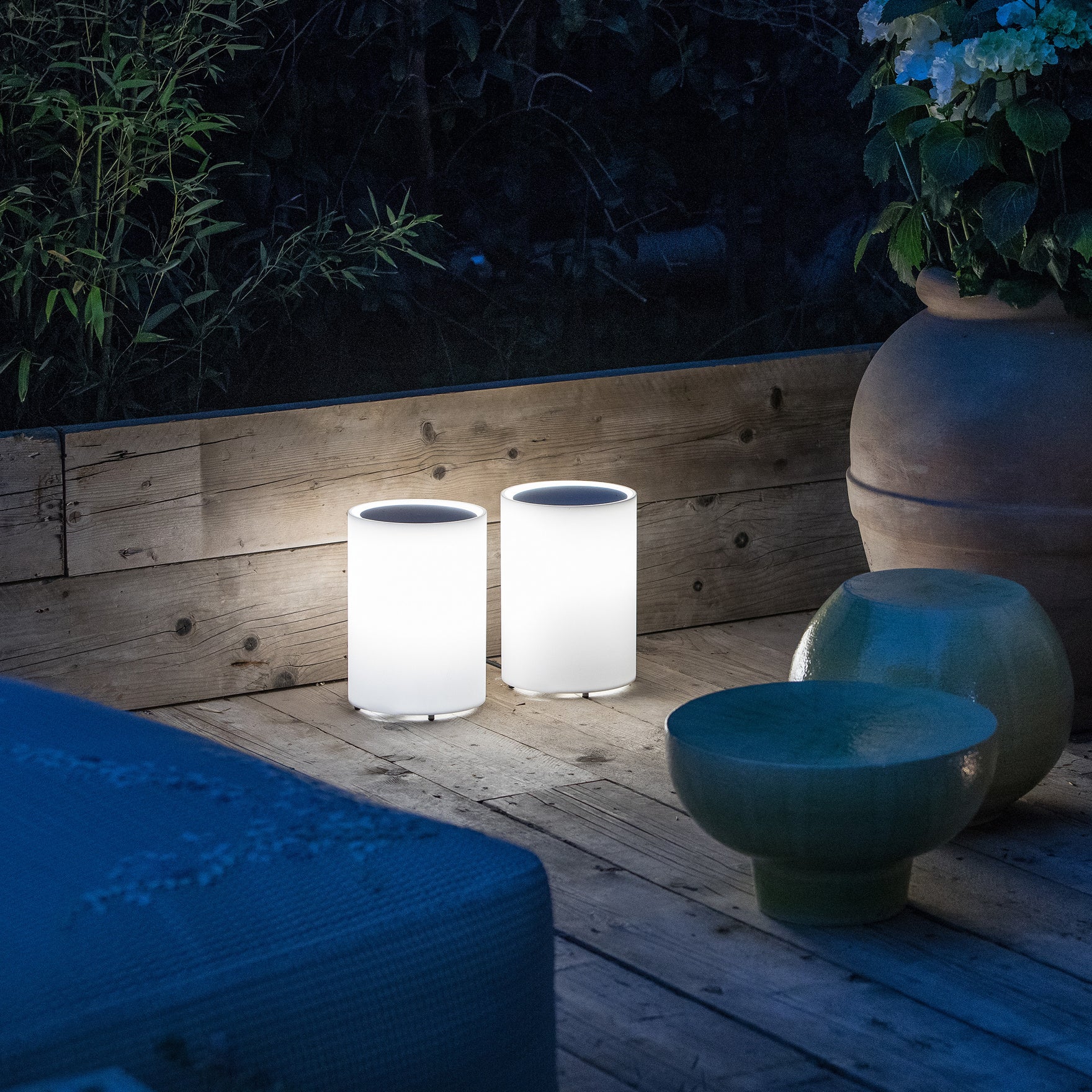 Lenta outdoor light in garden with timber deck & flower pots