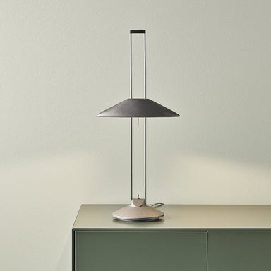 Adjustable metal table lamp on sideboard