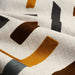 detail of fabric with abstract pattern in browns on cream background