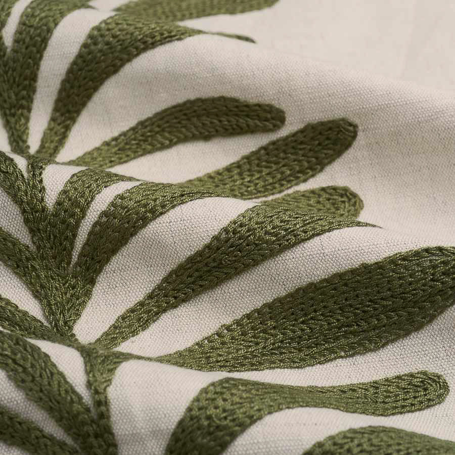 detail of embroidered fabric in olive and cream of leaves in stripe pattern