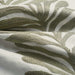 detail of embroidered fabric in pale green and cream of leaves in stripe pattern