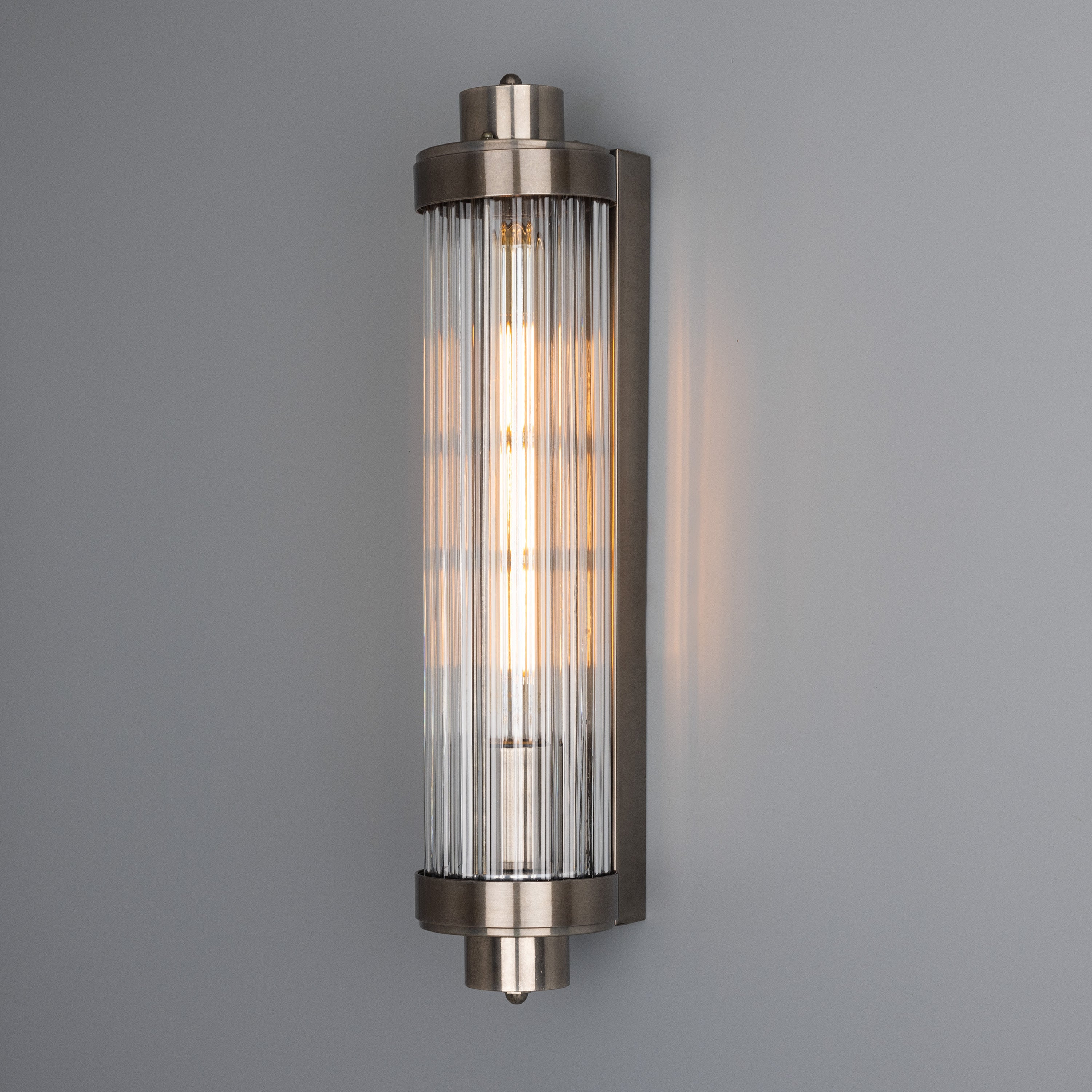 Retro Bathroom wall light fixture in Antique Silver on a grey background