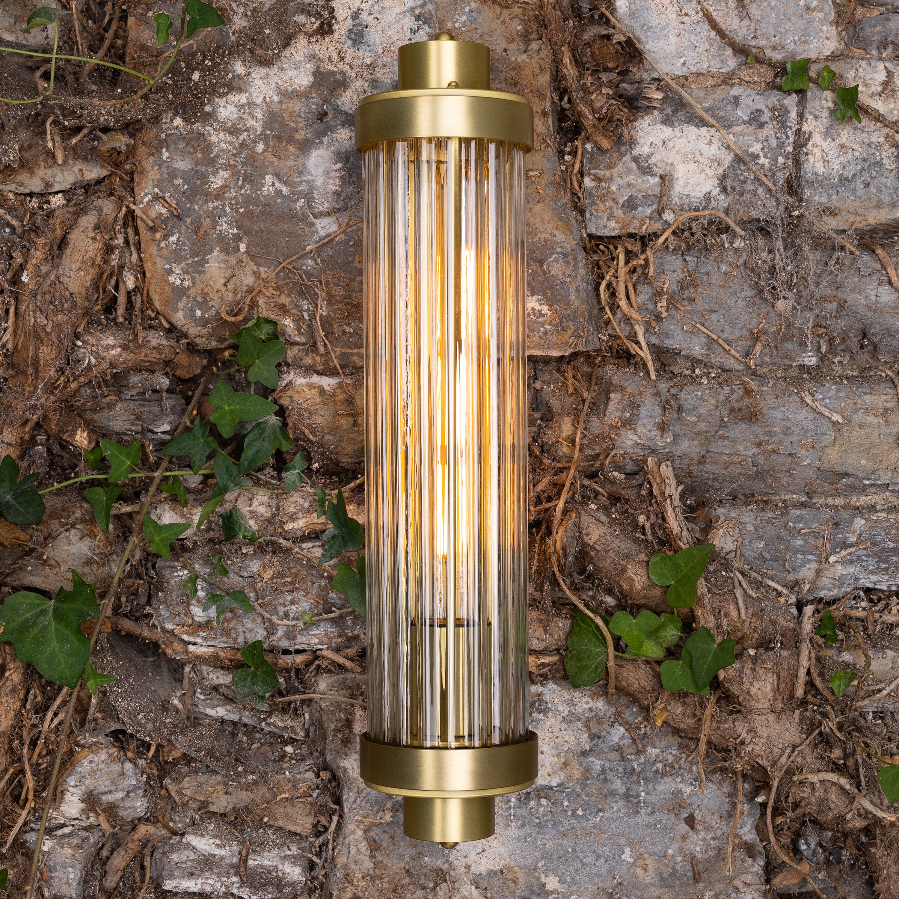 Retro Bathroom wall light fixture in Satin Brass on a grey background