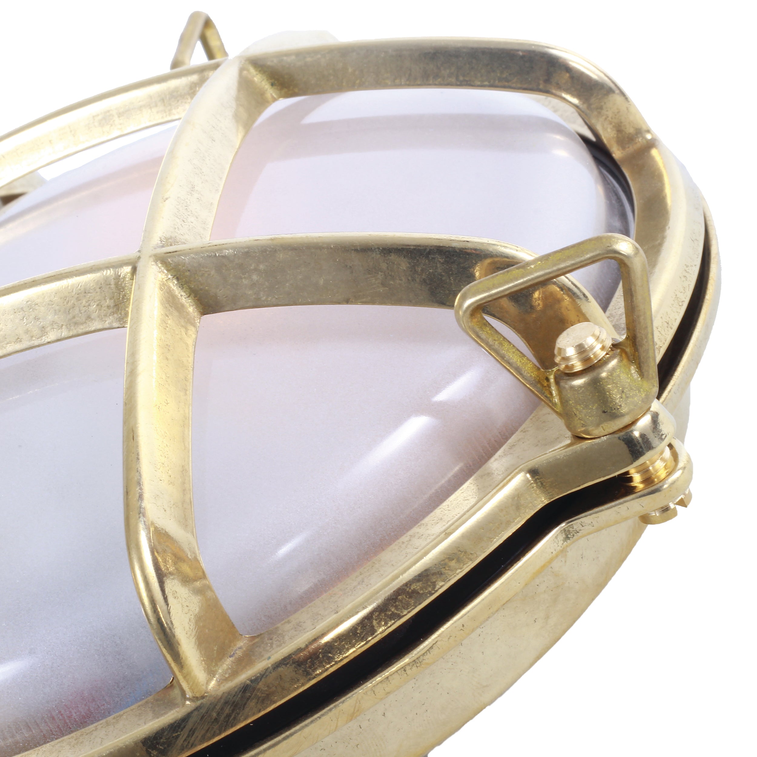 Round brass light fixture with grid design on a white background - detail