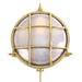 Round brass light fixture with glass cover on a white background