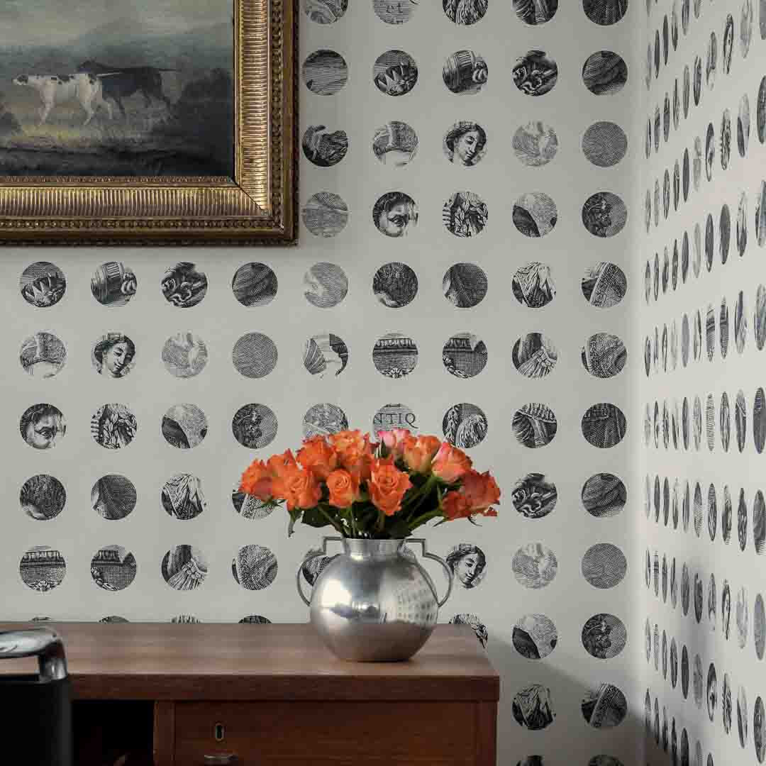Room interior with polka dot wallpaper, wooden cabinet, and vase of flowers.