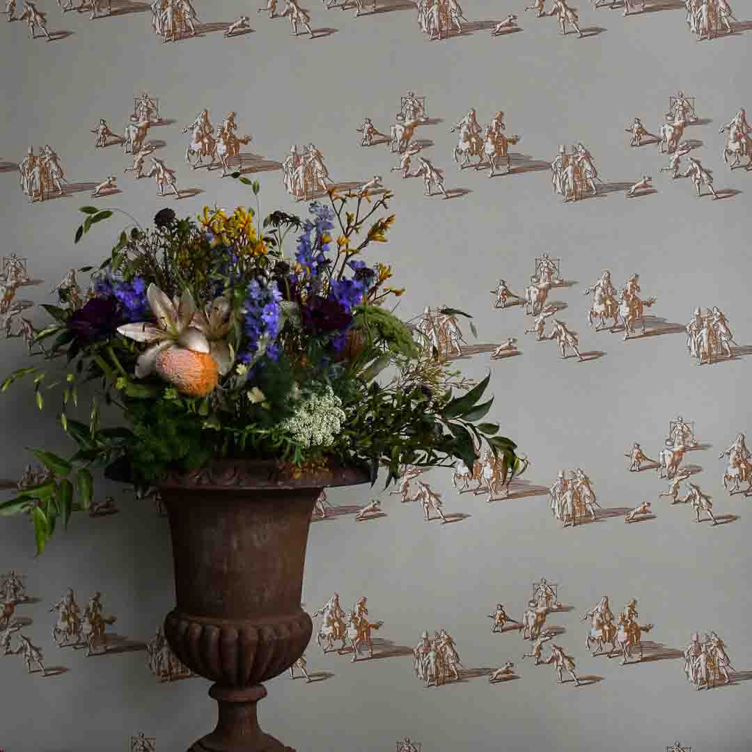 Floral arrangement in a urn against a decorative wallpaper with small figures.