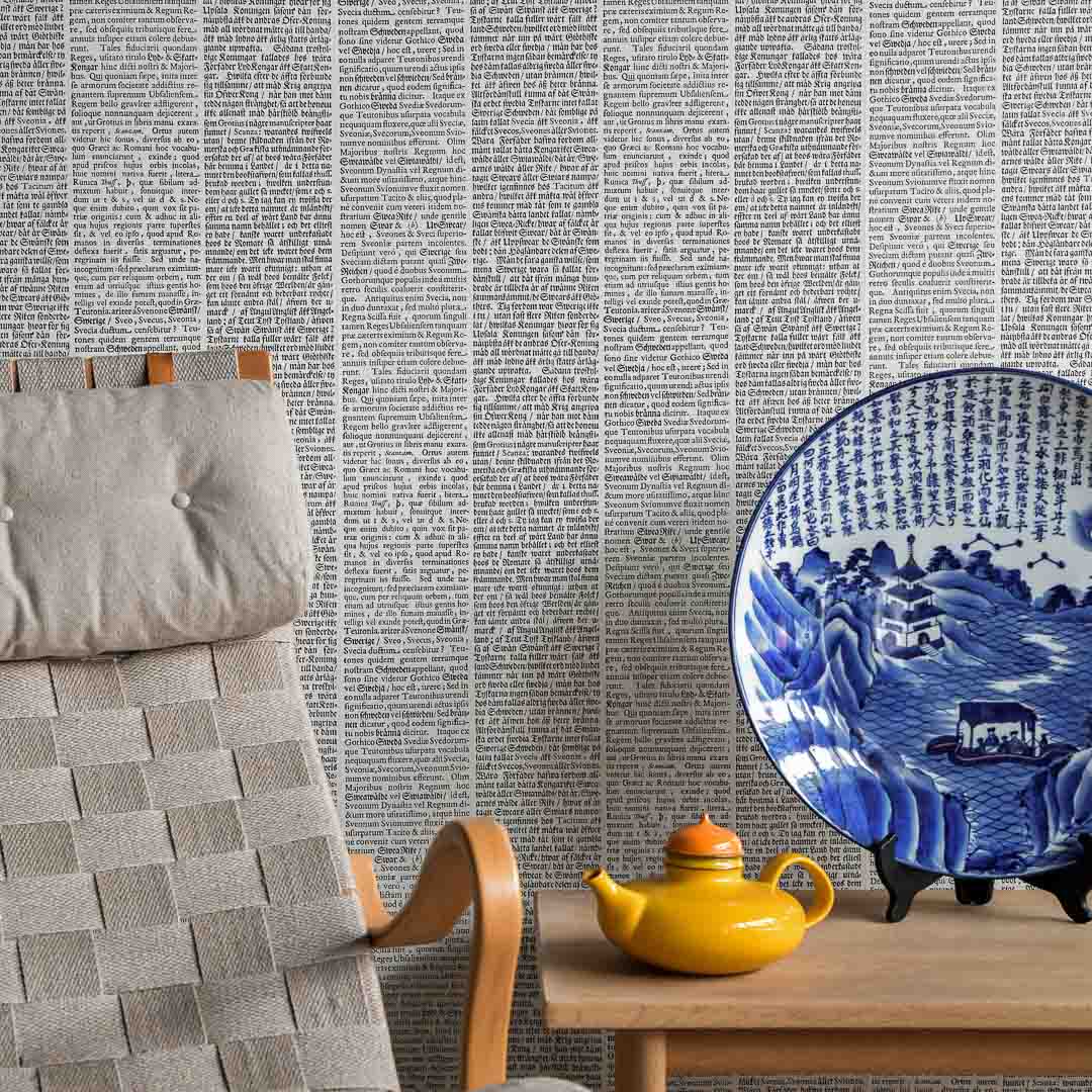 Room interior with a textured wall, chair, table, teapot, and decorative plate.