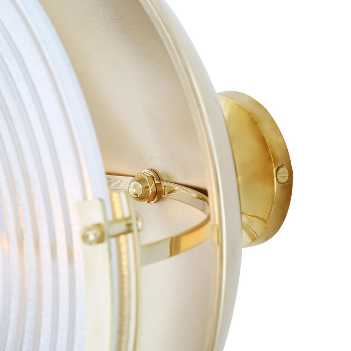 Close-up of a wall-mounted light fixture with brass accents on a white background