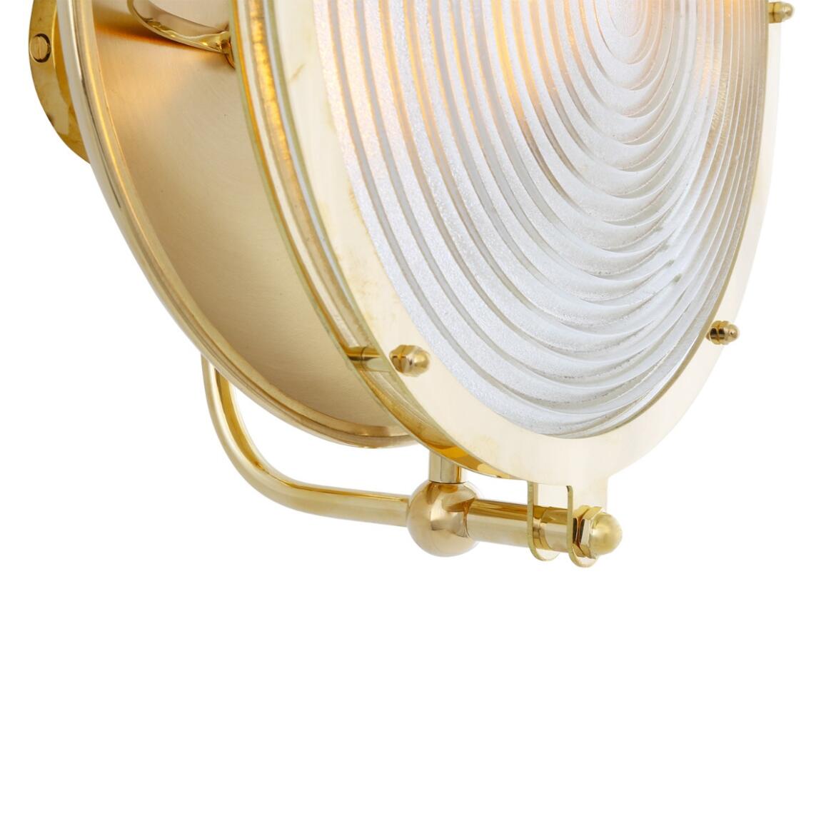 Brass wall sconce with white glass shade on a white background