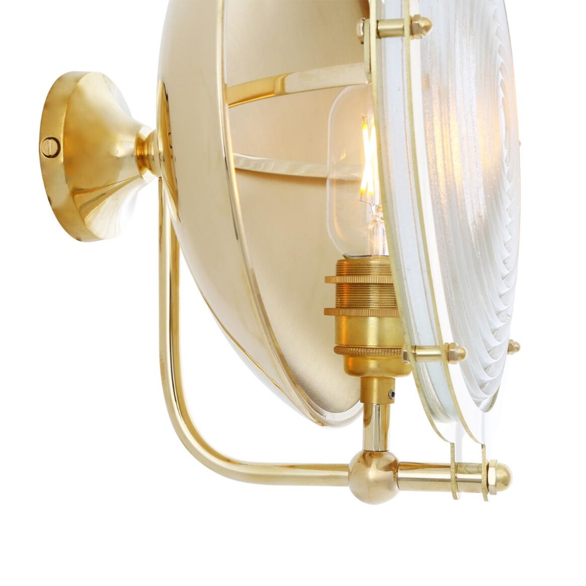 Brass wall-mounted lamp with a white glass shade on a white background