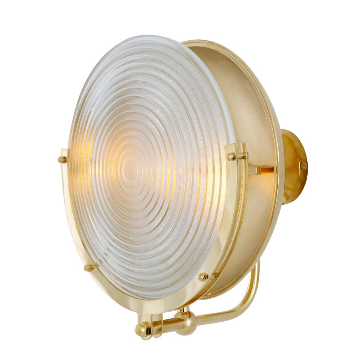 Brass wall light fixture with a white glass cover on a white background