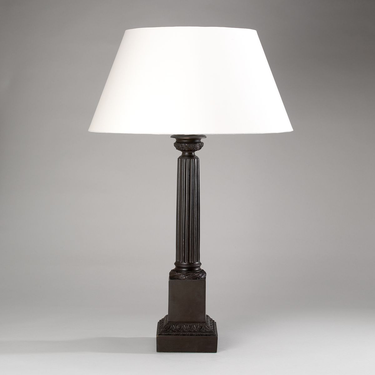 Bronze column lamp with laminated cream shade
