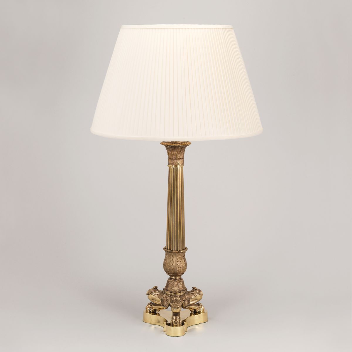 Brass column table lamp with silk pleated cream shade