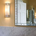 Nickel and glass art deco style wall light beside mirror and marble panel
