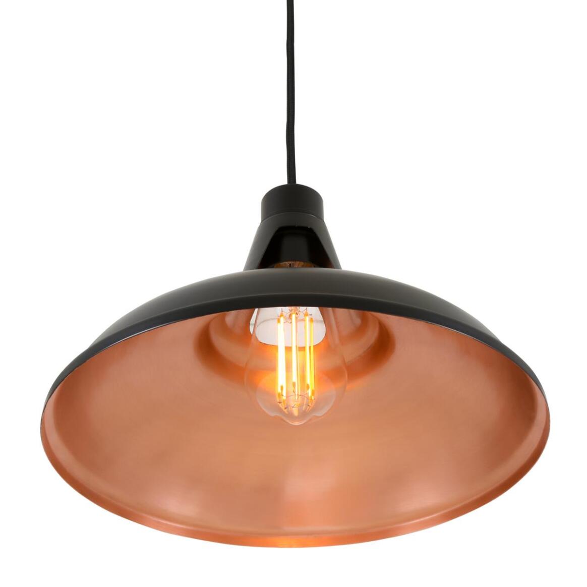 A modern industrial-style pendant light with a large dome-shaped shade featuring a black exterior and a warm copper interior, suspended by a black cord with an illuminated filament bulb inside.