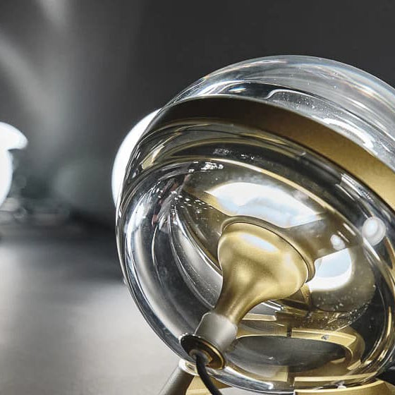 Elegant glass and brass sphere light showcasing contemporary luxury design by Nicholas Engert.