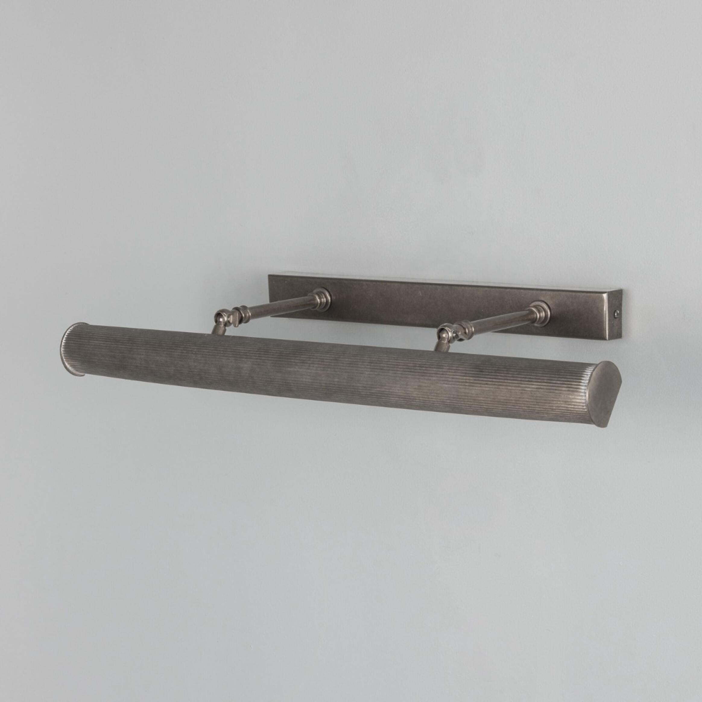 Metallic wall-mounted light fixture on a gray background