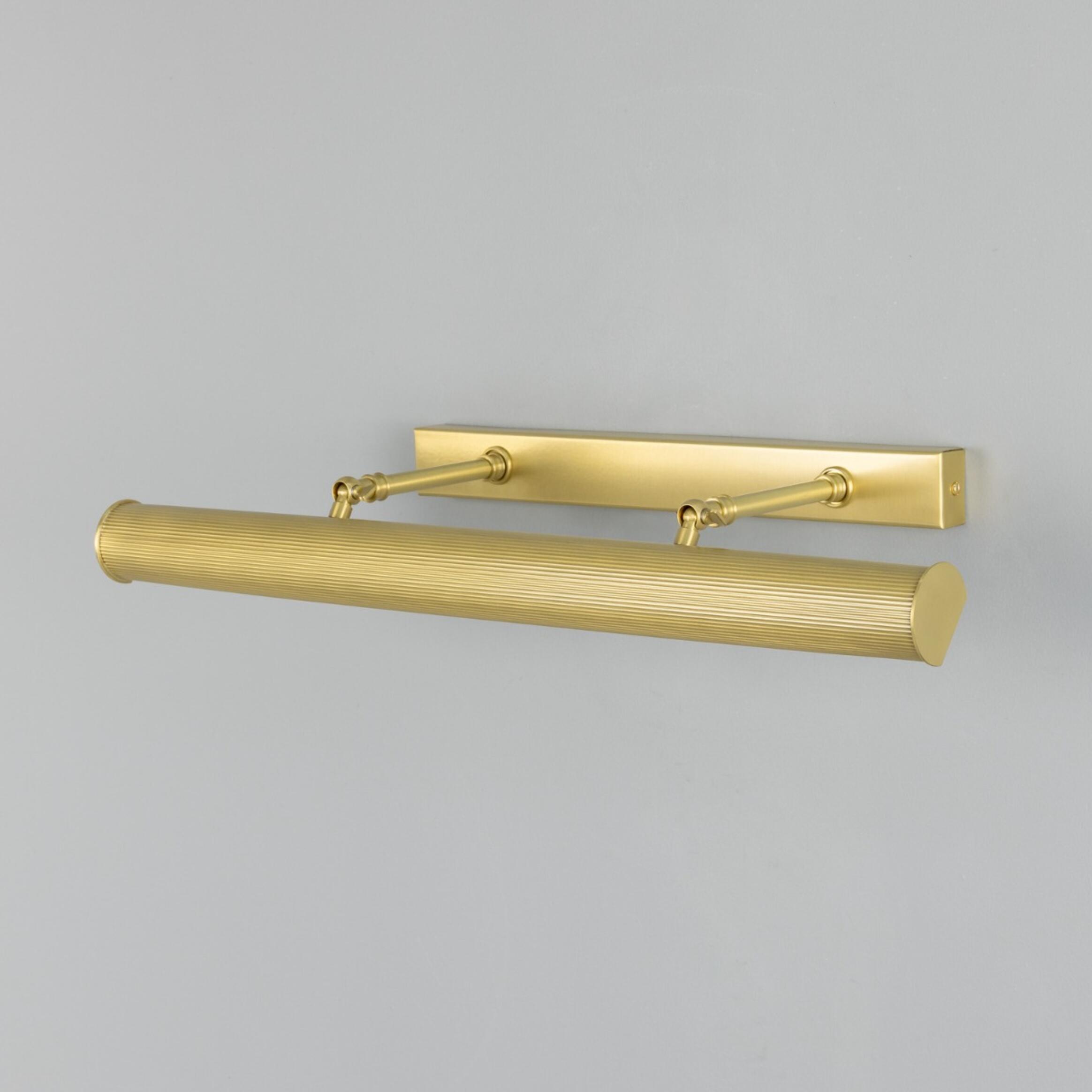 Brass wall-mounted light fixture on a grey background