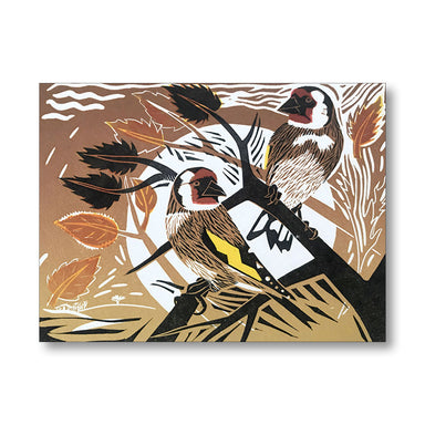 A square art print or card featuring two birds perched on branches, rendered in a stylized linocut or woodcut-like design with brown, black, white, yellow, and orange tones. The artwork is shown against a plain white background with a soft shadow.