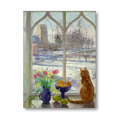 Cat sitting by a window with a view of a snowy landscape, flowers, and fruit on a table.