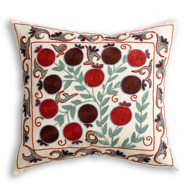 Suzani Silk Embroidered Stylised Floral Patterned Scatter Cushion on cream background with green leaves and red and burgundy coloured fruit