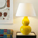 Gourd Shaped Vase Table Lamp in Crackled Mustard Yellow with Linen Laminated Lampshade on Table with Sofa and Painting