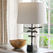 Cast Bronze Sculpted Table Lamp with Laminated Linen Lampshade on a Table Beside Window with Curtains